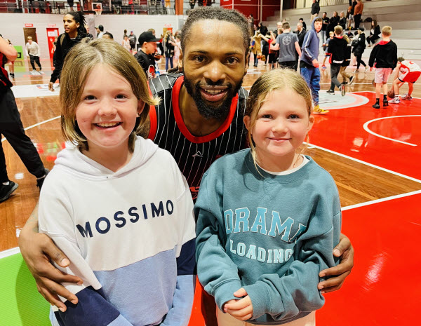Player and kids smiling at the camera